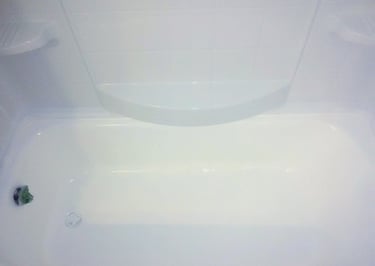 White glossy bathtub freshly refinished making it appear nearly new again