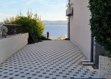 The picture shows private parking for guests and a sea view.