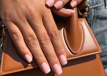 a woman's hand holding a purse and a purse