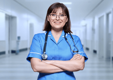 A smiling nurse in a blue uniform