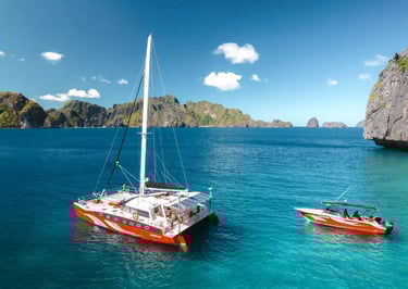 Private luxury yacht cruising through Bacuit Bay, El Nido.