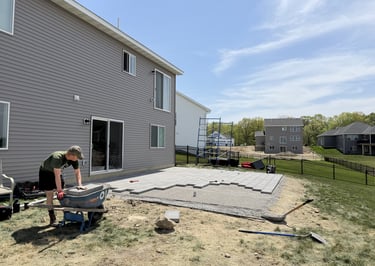 Oja Lawn & Landscape employee building paver patio