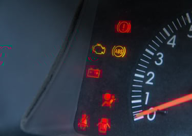 a car dashboard with warning lights ON