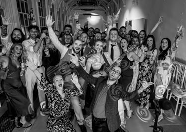 Bride and groom celebrating with wedding music duo family friends and guests