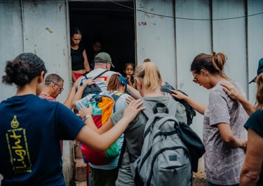 a group of people praying with hands on one another