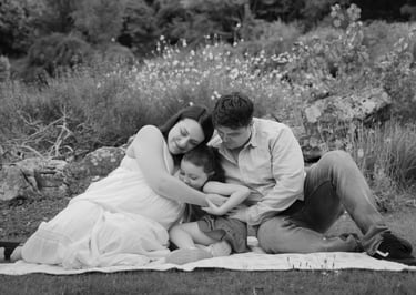 Black and white image family of three holding each other close