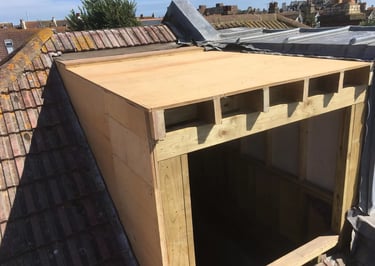 Timber dormer structure under construction during loft conversion in Brighton.