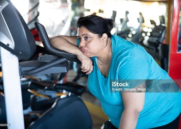 a woman in a blue shirt is standing in front of a machine