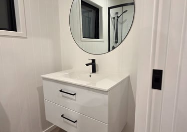Bathroom vanity with large round mirror