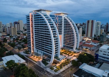 Modern luxury high-rise architecture of BS Design Corporate Towers in Fortaleza city skyline at twilight.