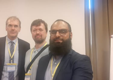 three men standing in front of a white board