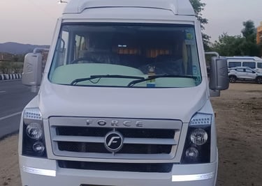 a Forc trmpo traveler parked on the side of a road