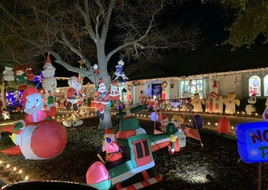 a house with christmas lights and holiday decorations on display