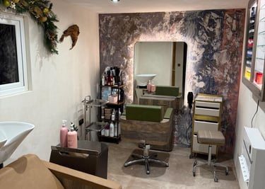 Modern interior of a hair salon with microcement finish, professional chairs, backlit mirrors and ha