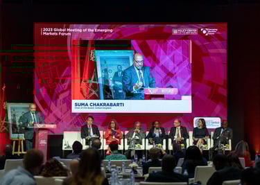 a man in a suit and tie is speaking into a microphone