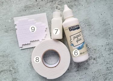 Set of card making adhesives and glue on a glass surface