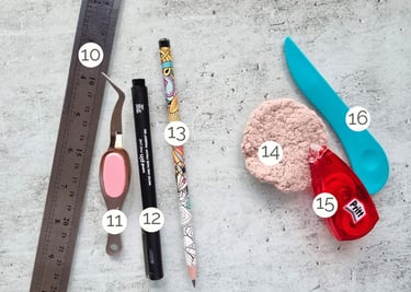 Set of card making tools: ruler, tweezers, pens, glue, bone knife.