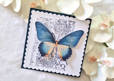 Handmade card with big blue butterfly on a dark blue card stock and stamped background