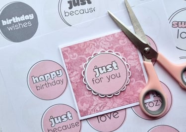 Printed sheets with circular sentiments on them, pink handmade card with "Just for You" sentiment.