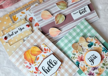 A collection of four handmade greeting cards with autumn themes. The colors are warm and inviting.