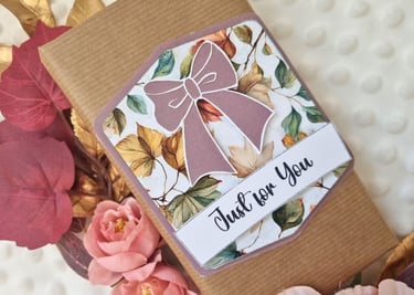 Handmade gift tag with purple ribbon and "just for you" sentiment on wrapped gift in brown paper.