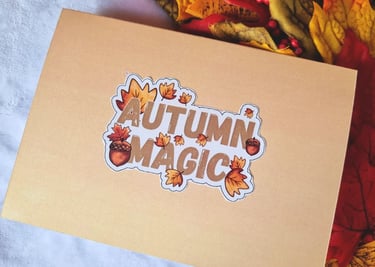 Orange back of the card with a sticker on it saying "Autumn Magic"