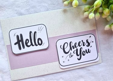 Two handmade greeting cards with "Hello" and "Cheers to You" sentiments on it