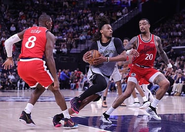 Stephon Castle of the Spurs controls the ball against Kris Dunn and John Collins of the Clippers