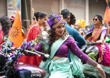 woman in maharastrian traditional outfit riding a motorbike in girgaon gudipadwa shobhayatra 2025