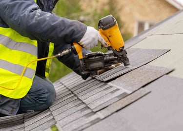 Roofer installing shingles
