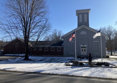 gray country church with american and christian flags