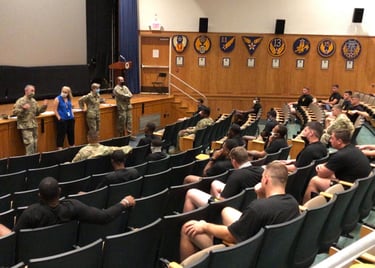 Dr. Hooton, in blue, with History faculty and students in an auditorium discussing teaching and race