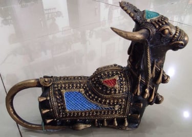  "Handcrafted brass bull sculpture with red and blue accents on the back – tribal-style-for overseas demand"