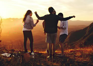 a group of people standing on a hill top