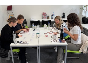 Learners completing first aid training activities at a table. 