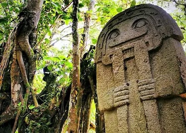 Ancient stone statue monolith standing in the lush jungle of San Agustín Archaeological Park.
