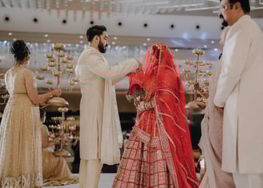 a man and woman in traditional indian wedding attire