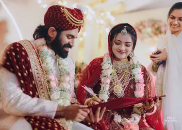 a man and woman in traditional indian wedding attire