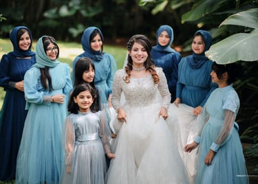 a woman in a white dress and a group of women in blue dresses