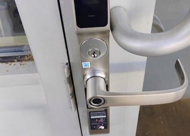 Biometric keypad smart lock on commercial building entrance