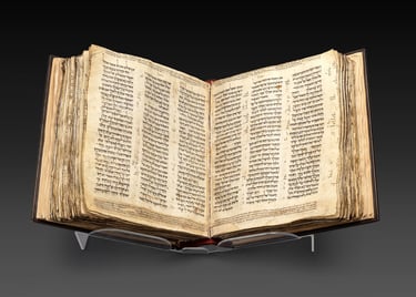 Ancient Hebrew Bible manuscript displayed open, showcasing historic text in Hebrew script