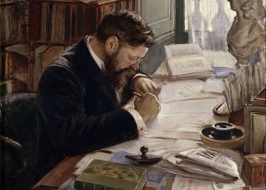 a man sitting at a table with a book and a book