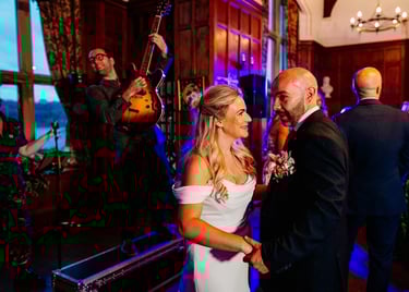 Bride and Groom having first dance with wedding singer musicians