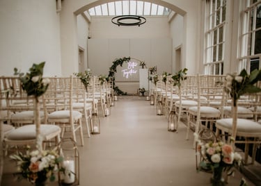 a wedding ceremony with a large window and flowers