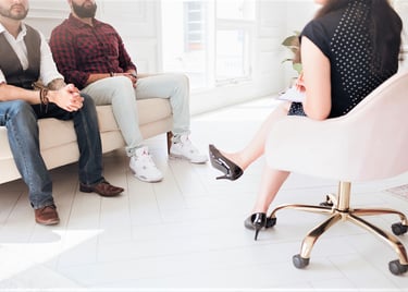 2 men seated together in an office