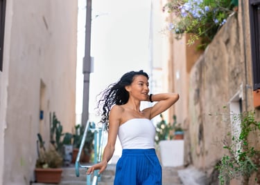 A girl walking down stairs with a radiant smile, elegantly captured in a candid moment of joy.