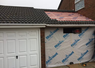 Garage conversion in progress with roof work and structural preparation in Brighton.