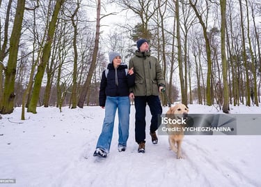 a man and woman walking in the snow