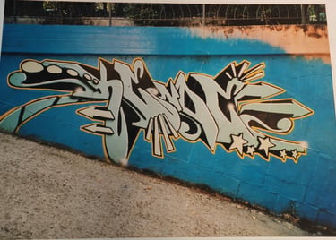 Street graffiti on building wall — urban calligraphy writing scene Europe Kende