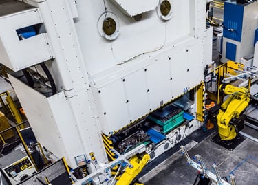 a factory with robots tending a press